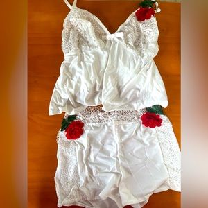 New in packaging, white silky lingerie set with lace and rose detailing.